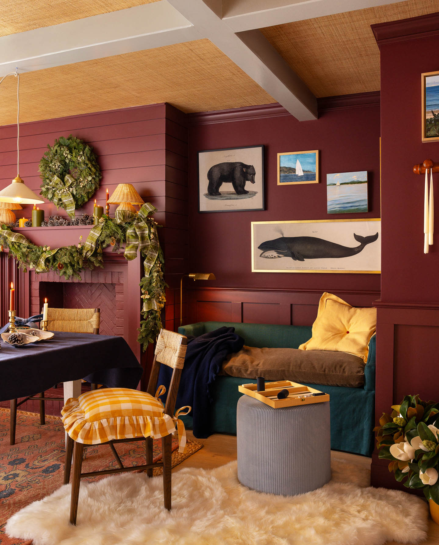 gallery wall of animal prints next to a fireplace in a moody red room