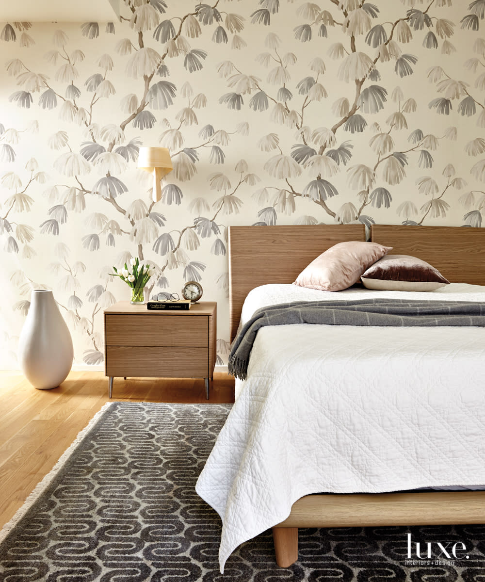 calming bedroom with a natural botanical wallpaper, modern bed frame and large floor vase