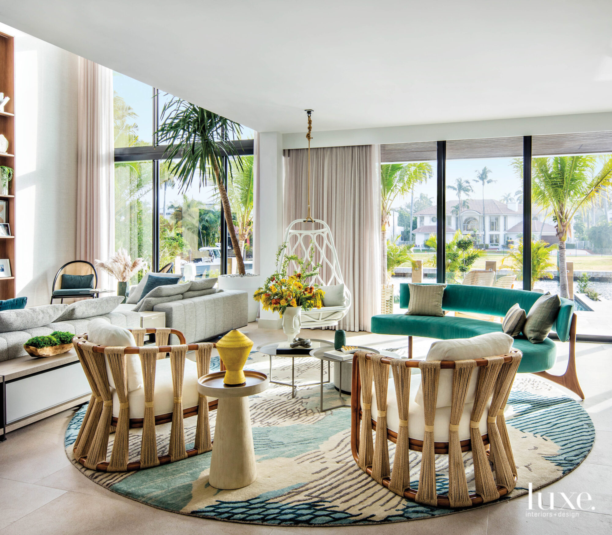 Family room with hanging chair and green sofa.