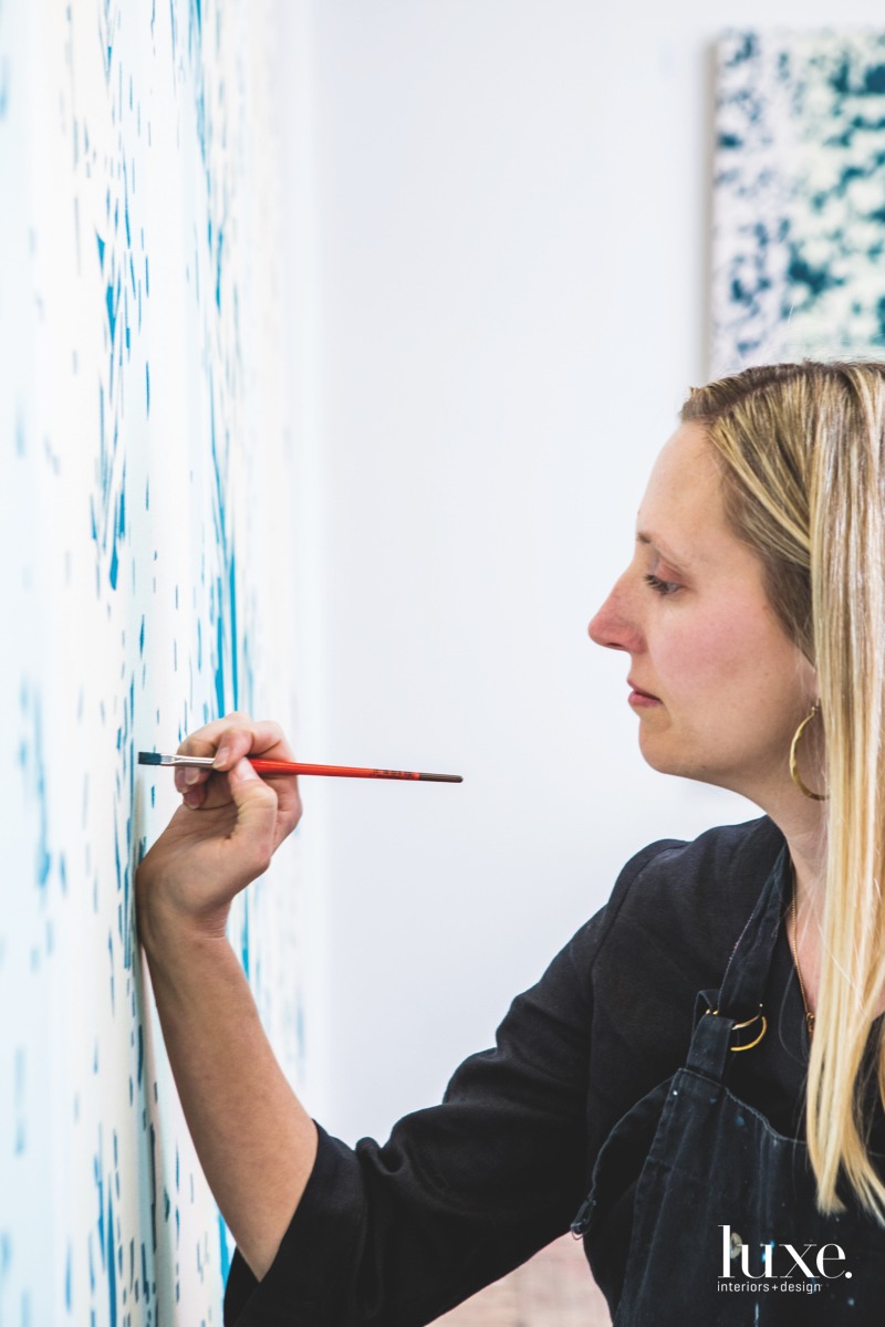 Denver artist Mindy Bray works on Veiled, a painting based on an image of a willow tree.