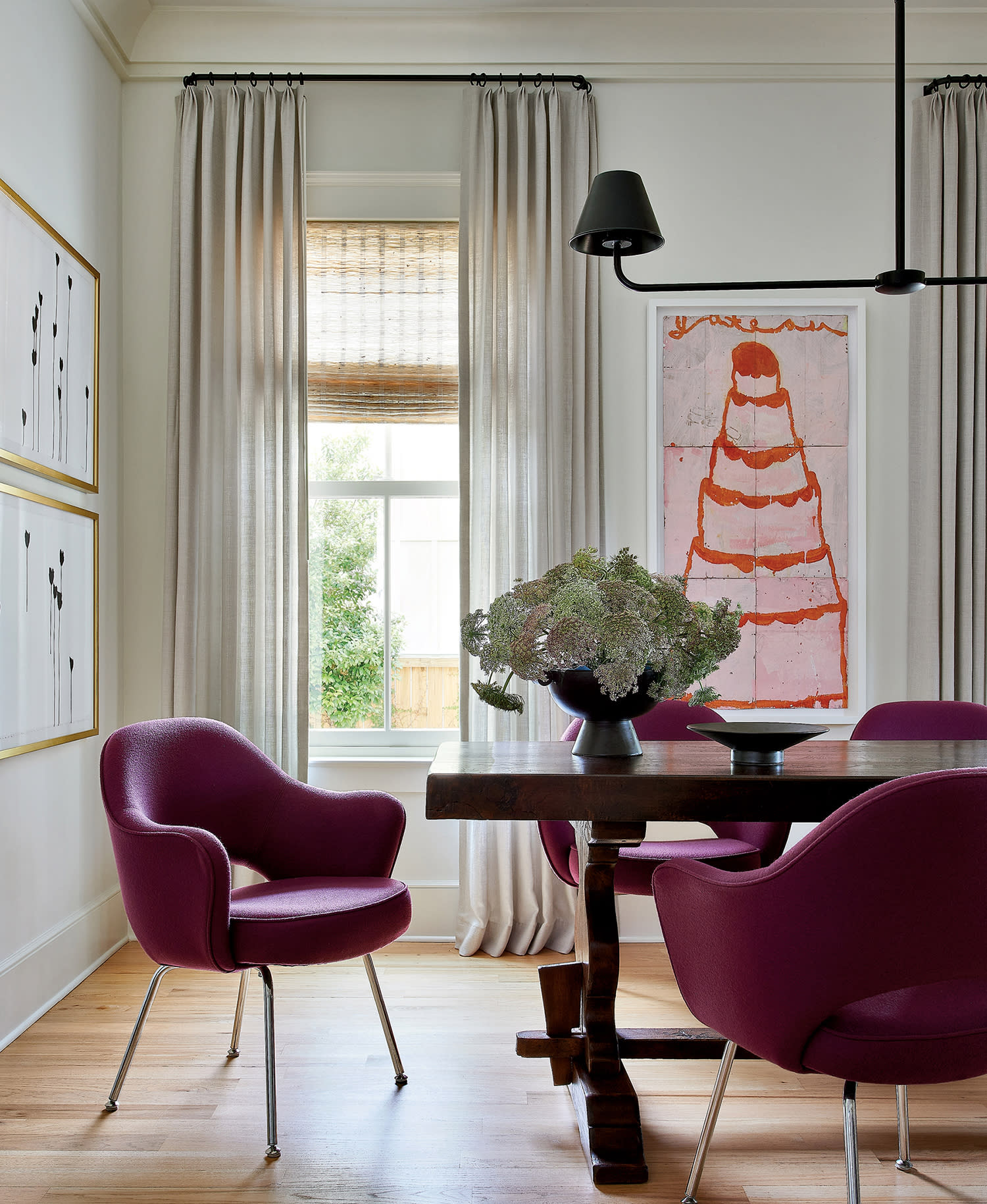 traditional dining room with a vintage table and mauve chairs in an Alabama cottage