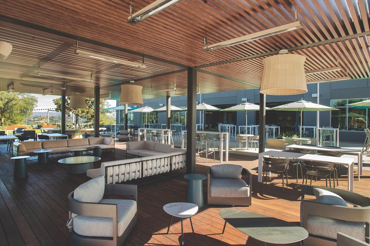 An outdoor patio at the hotel showcases a wooden ceiling, creating an inviting atmosphere for guests to unwind.