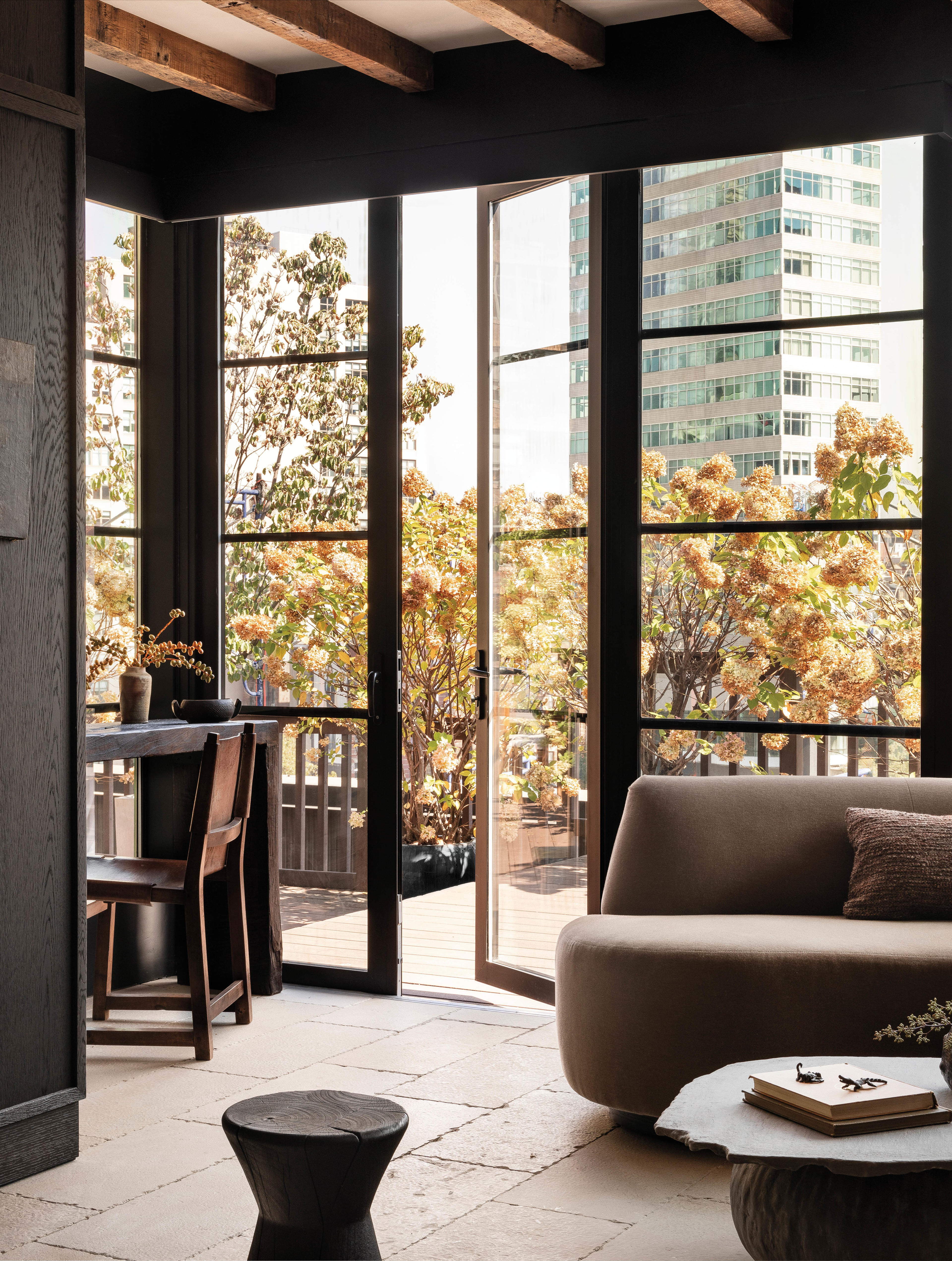 a doorway opens to the terrace of a Tribeca home with rustic yet elegant style