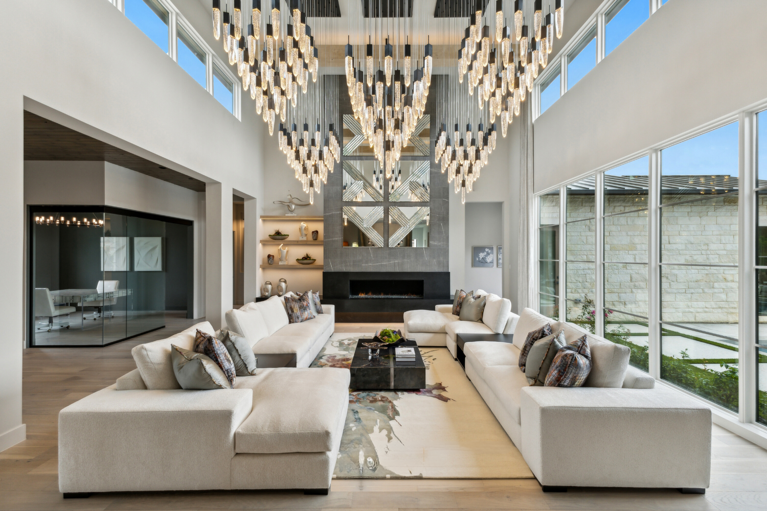 Modern Whimsy, Southlake: An expansive living room highlighted by a magnificent lighting, creating a luxurious ambiance in the beautifully designed space.