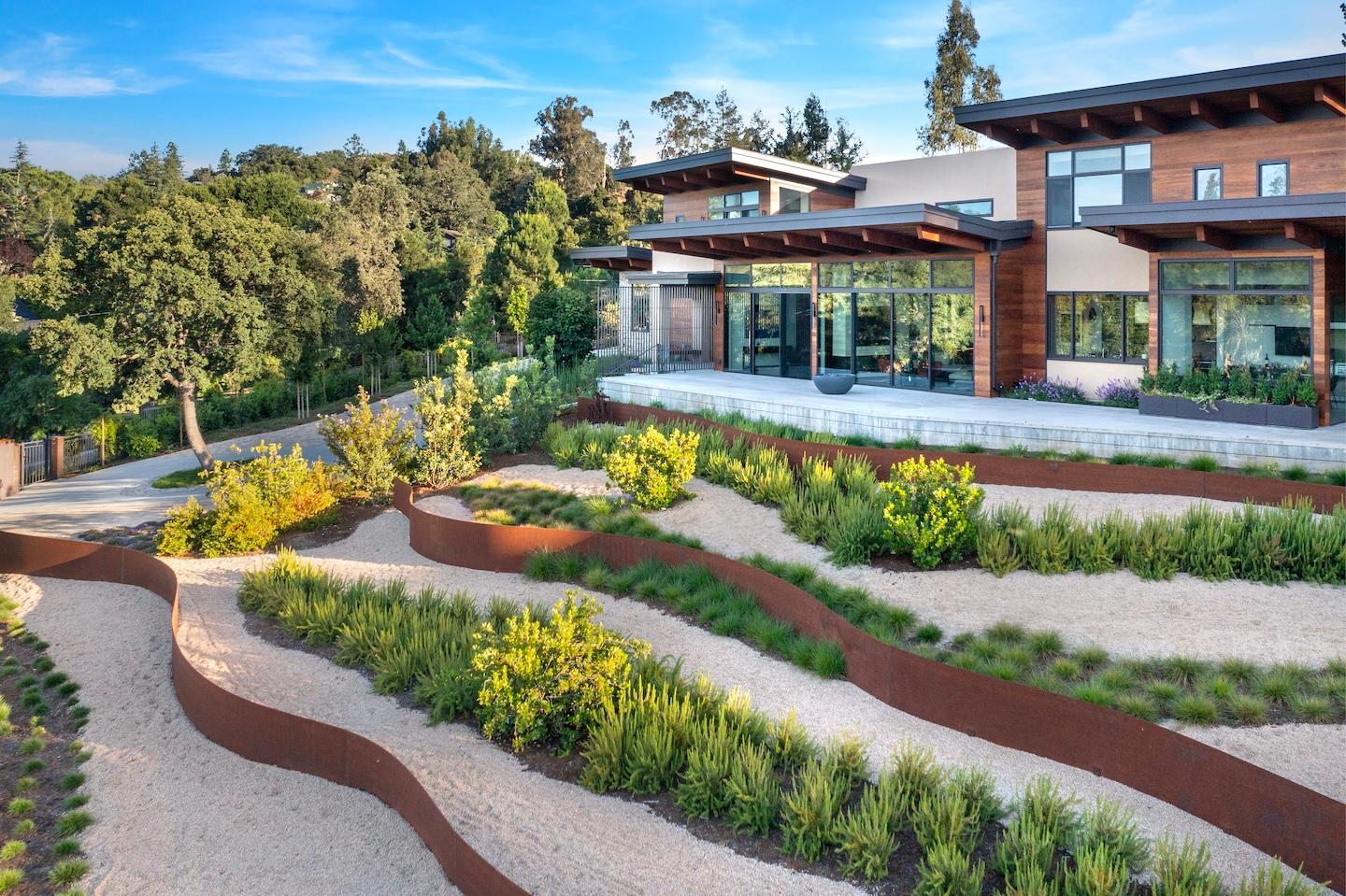 This elegant landscaping and contemporary home built by Conrado Home Builders.