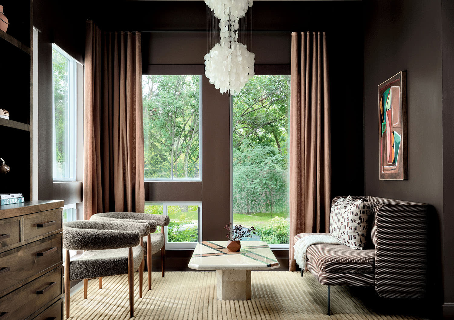 brown bedroom seating area with a 1960s mother-of-pearl petal chandelier