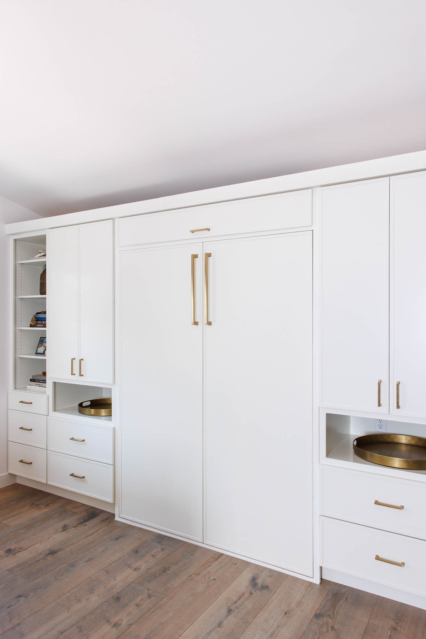 white cabinetry covering a Murphy bed