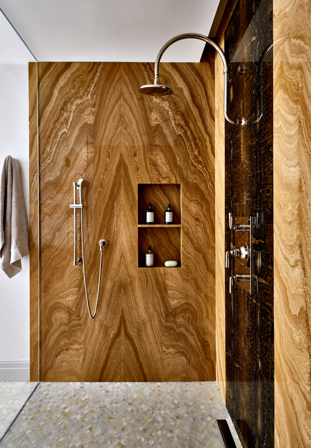 semiprecious onyx forms the shower wall in this bathroom