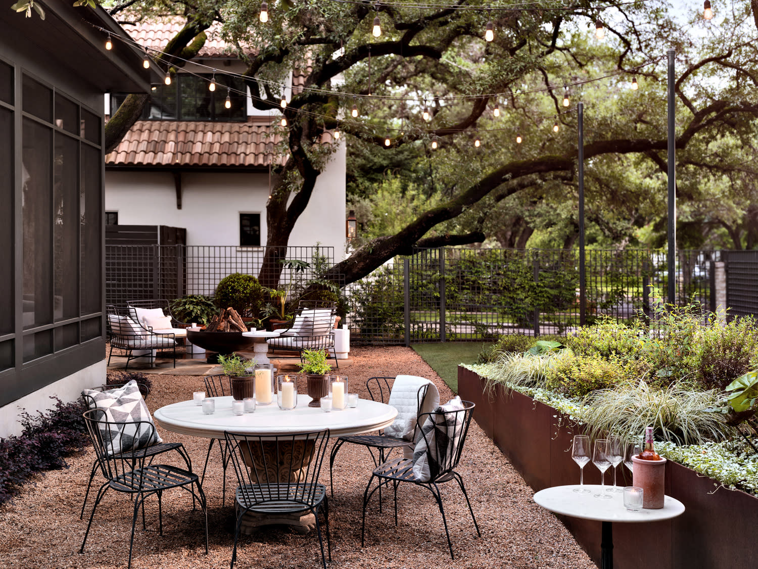 A cozy patio area with a table and chairs, perfect for enjoying meals or gatherings outside.