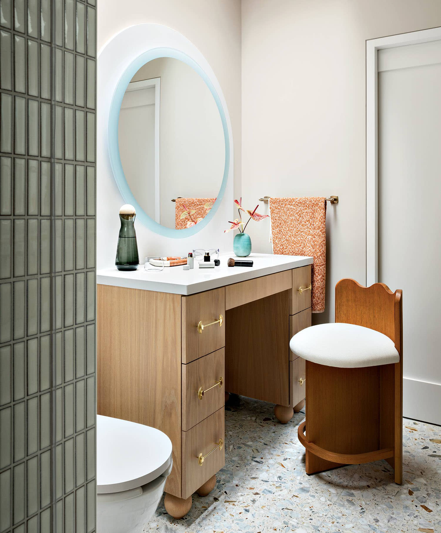 playful contemporary bathroom with a scalloped stool pulling up to a vanity
