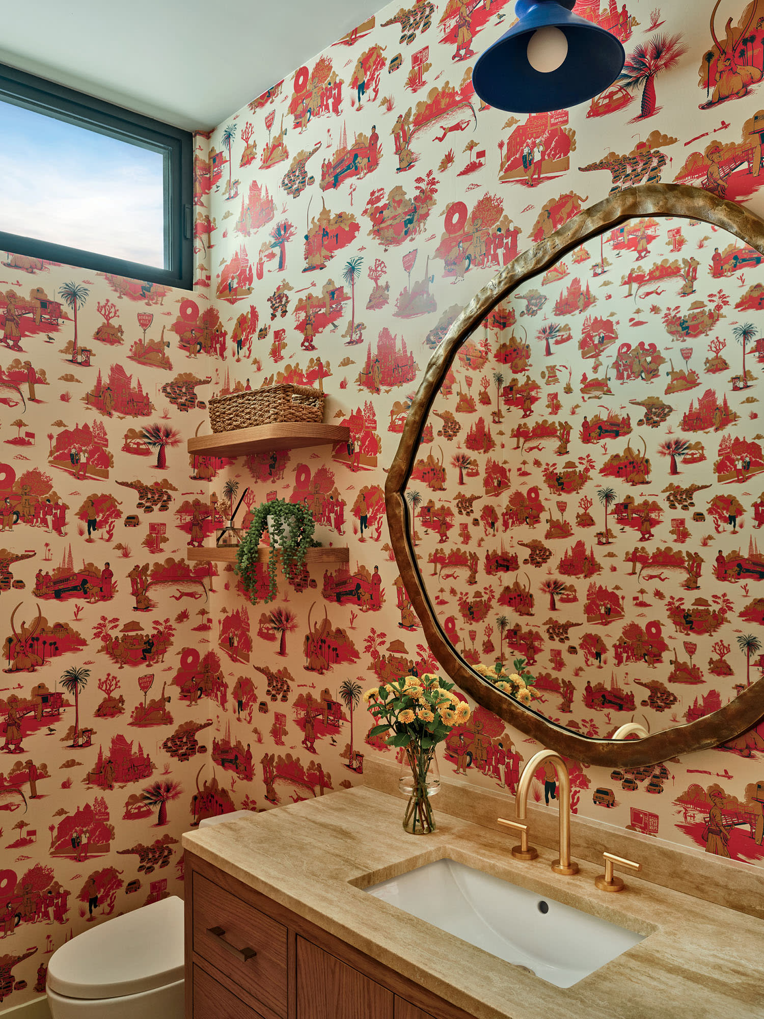 Bathroom with vibrant, whimsical wallpaper featuring red and orange patterns. 