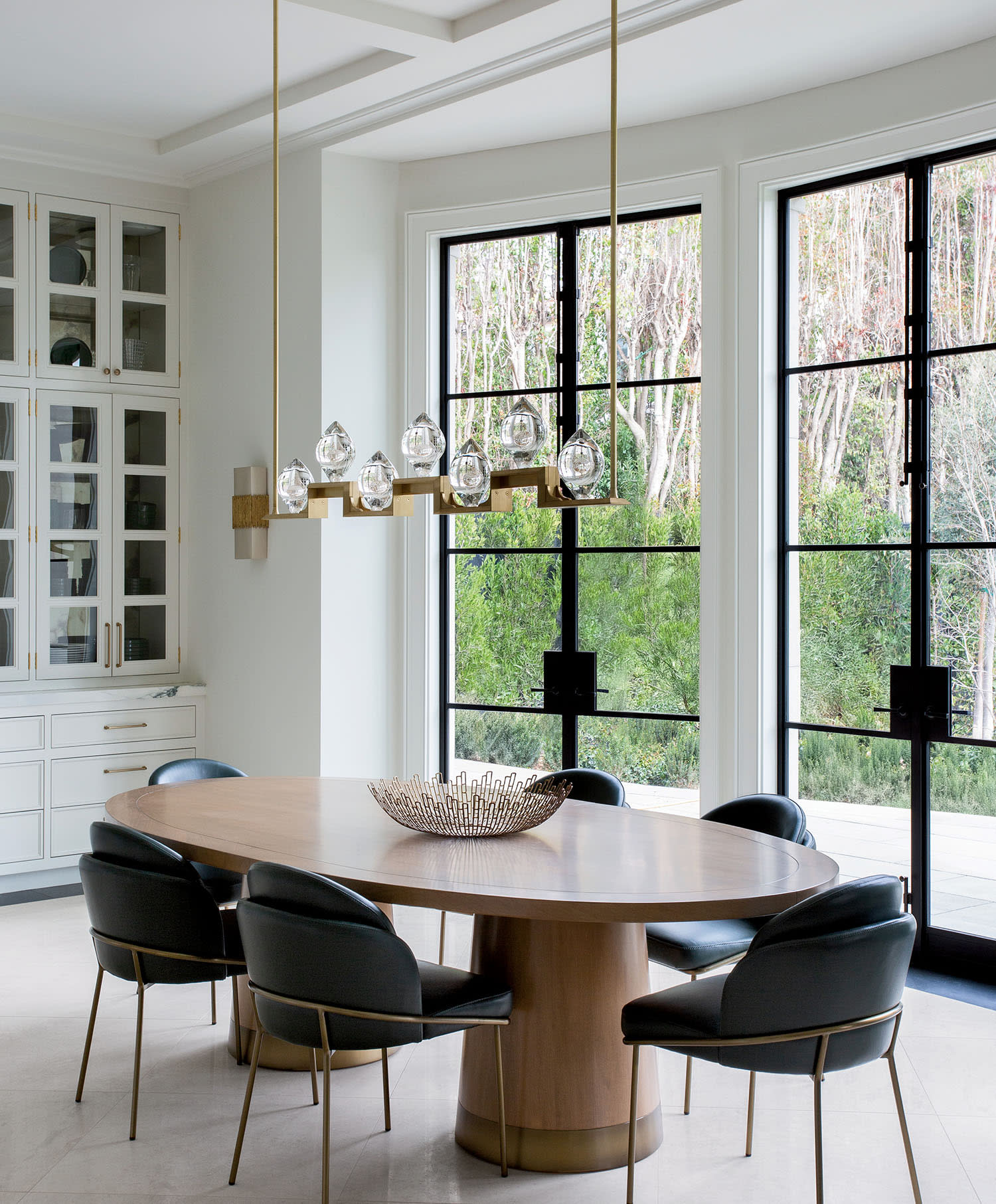 transitional dining room with an oak table and green chairs