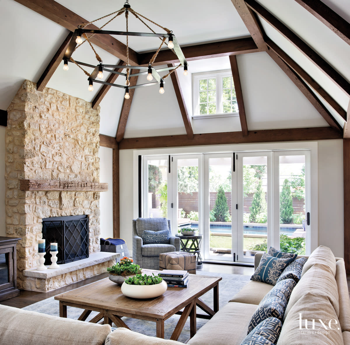 Family room with high ceilings and dark wood beams.