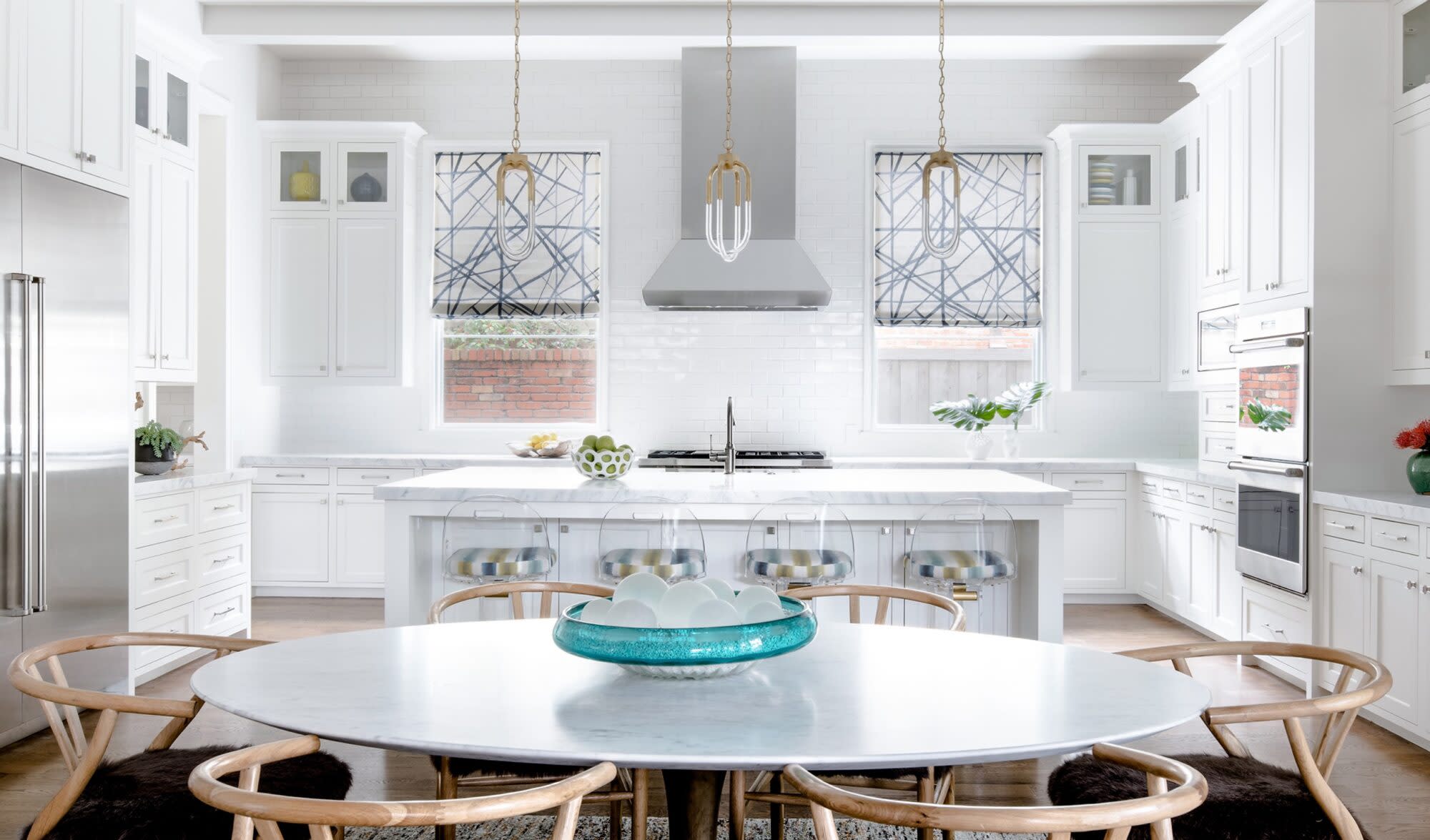 a kitchen with a round table and chairs