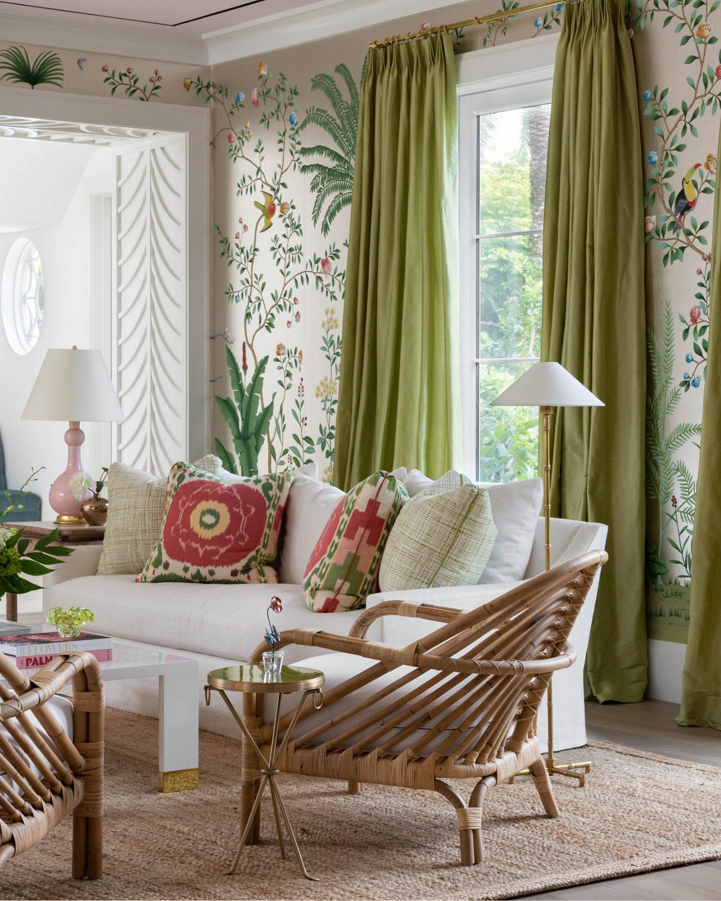 contemporary lounge with a tropical floral wallcovering and green curtains