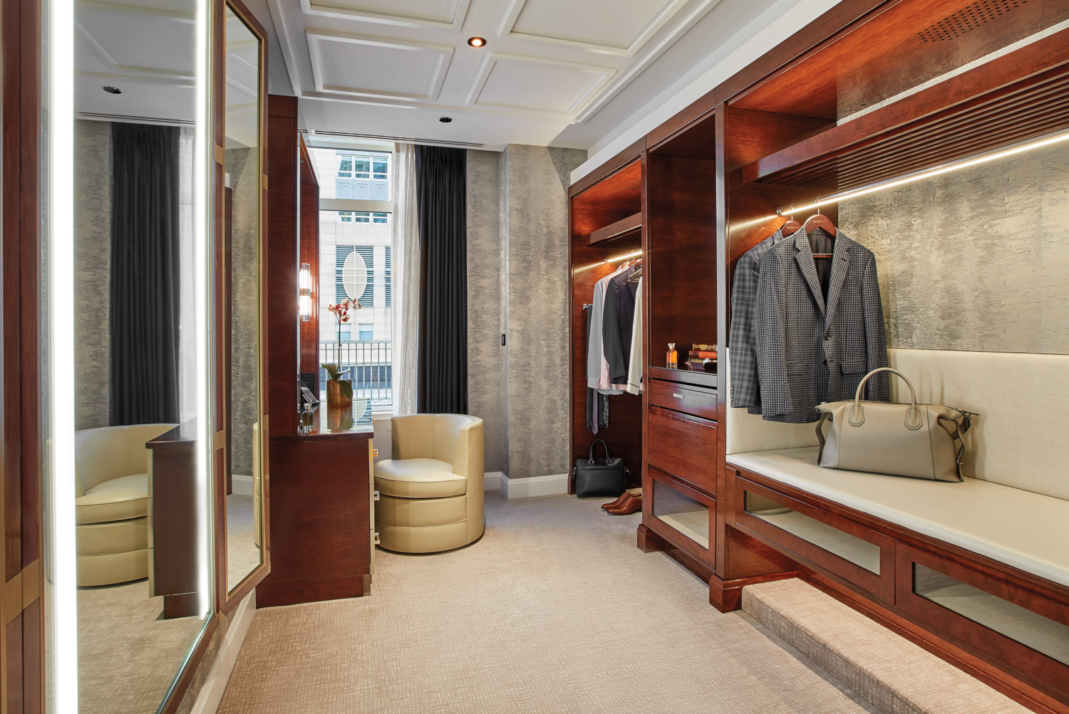 Walk-in closet in hotel suite with wood shelving