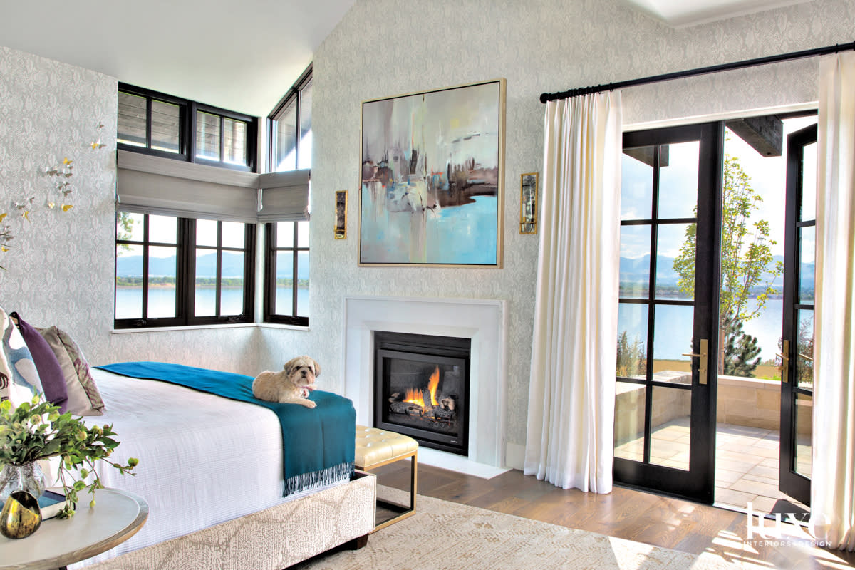 primary bedroom with fireplace and artwork