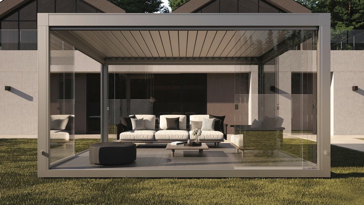 A contemporary outdoor living room featuring a sleek glass roof, surrounded by stylish furniture and greenery.  