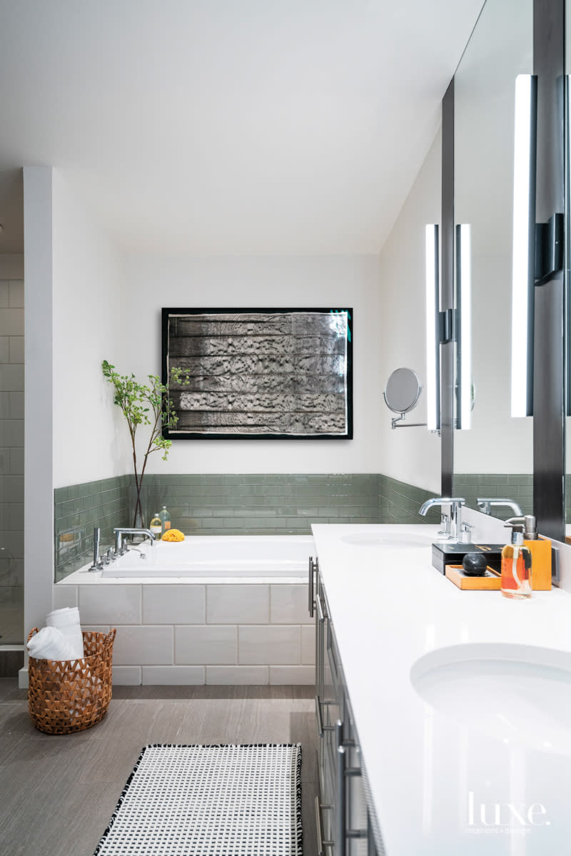 contemporary master bathroom with green ann sacks glass tile around tub