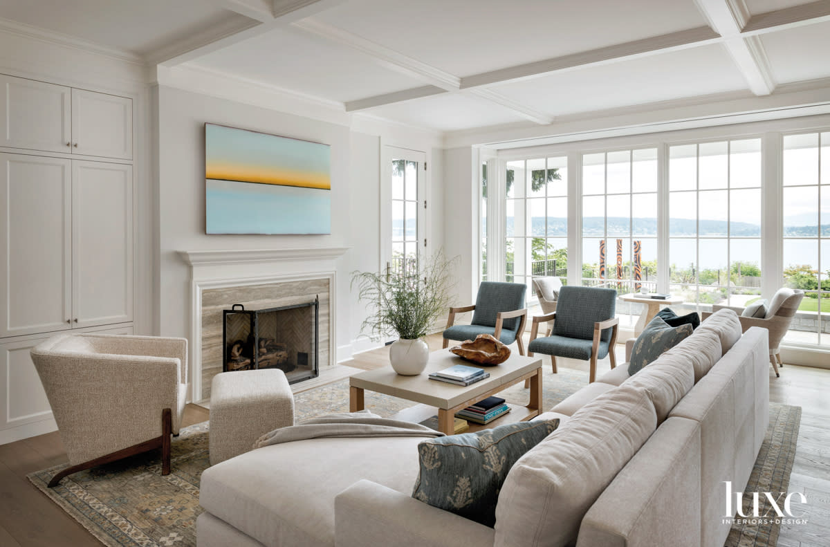 Living room with large sectional and wood frame armchairs