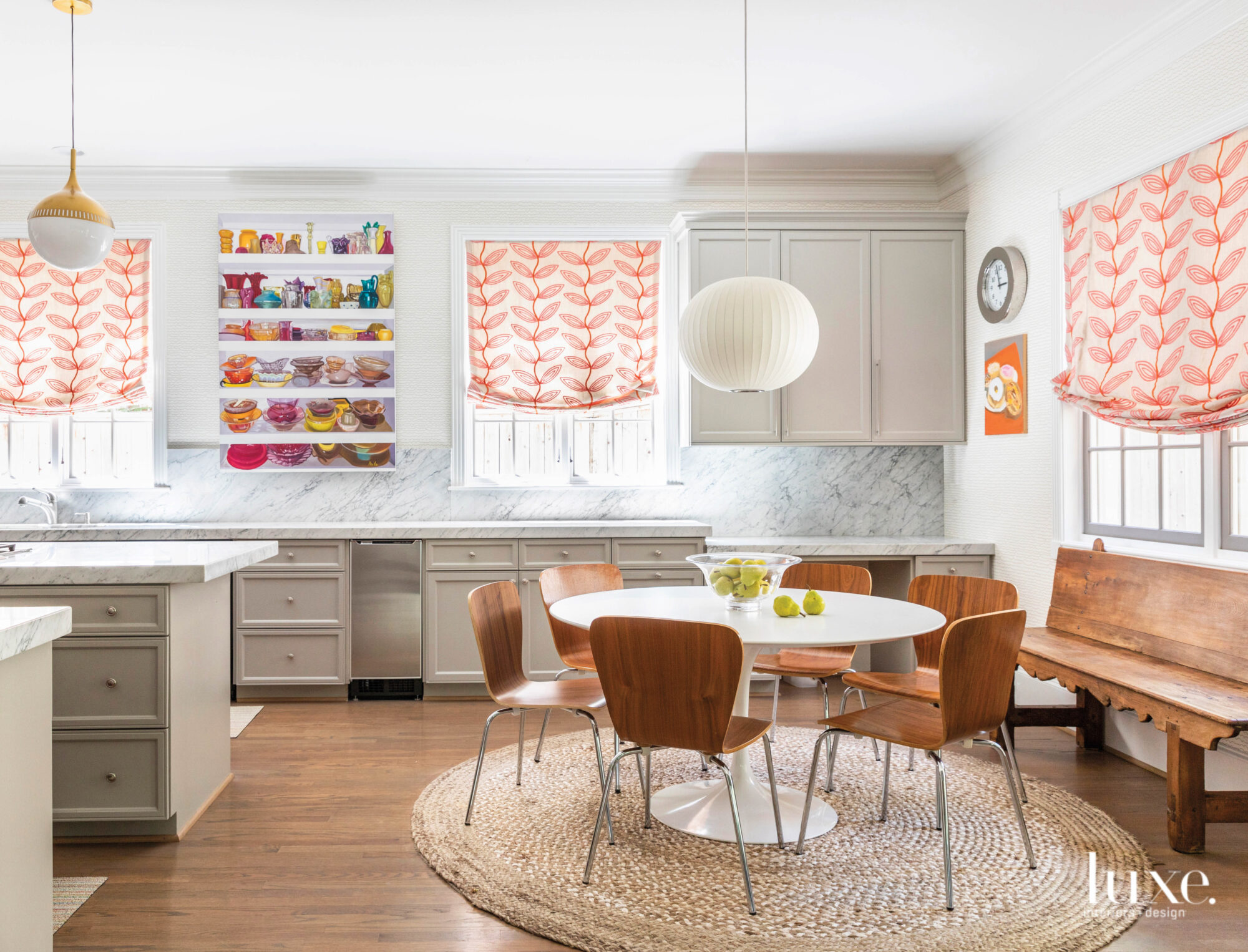 Round dining table in open kitchen full of colorful art