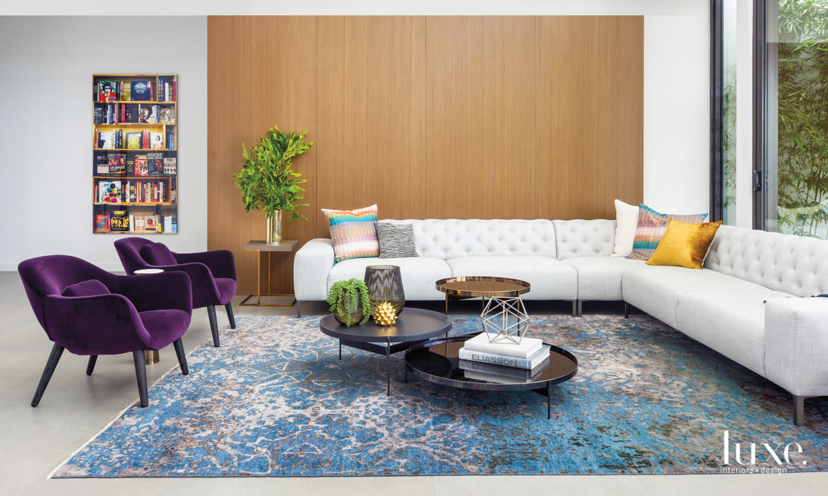 living area with purple chairs and white sectional