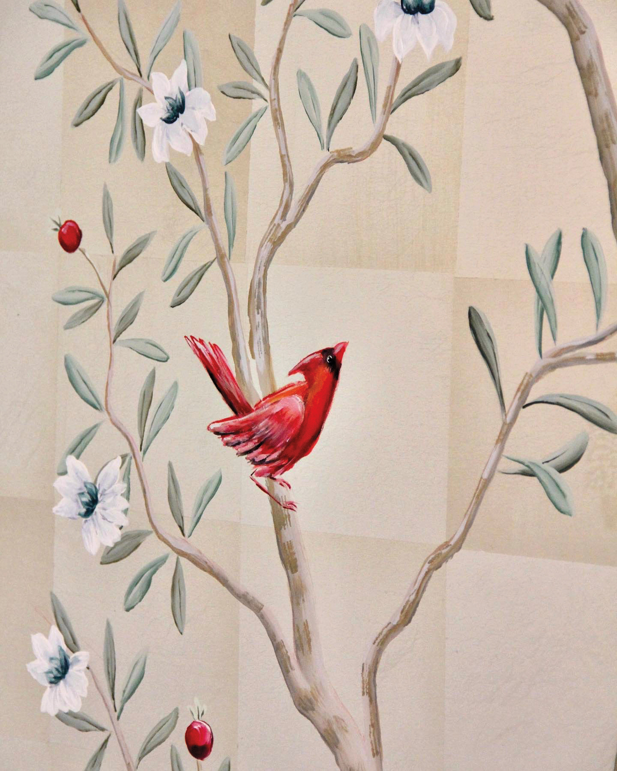 hand-painted wall mural of a red cardinal perched on a tree branch with white flowers