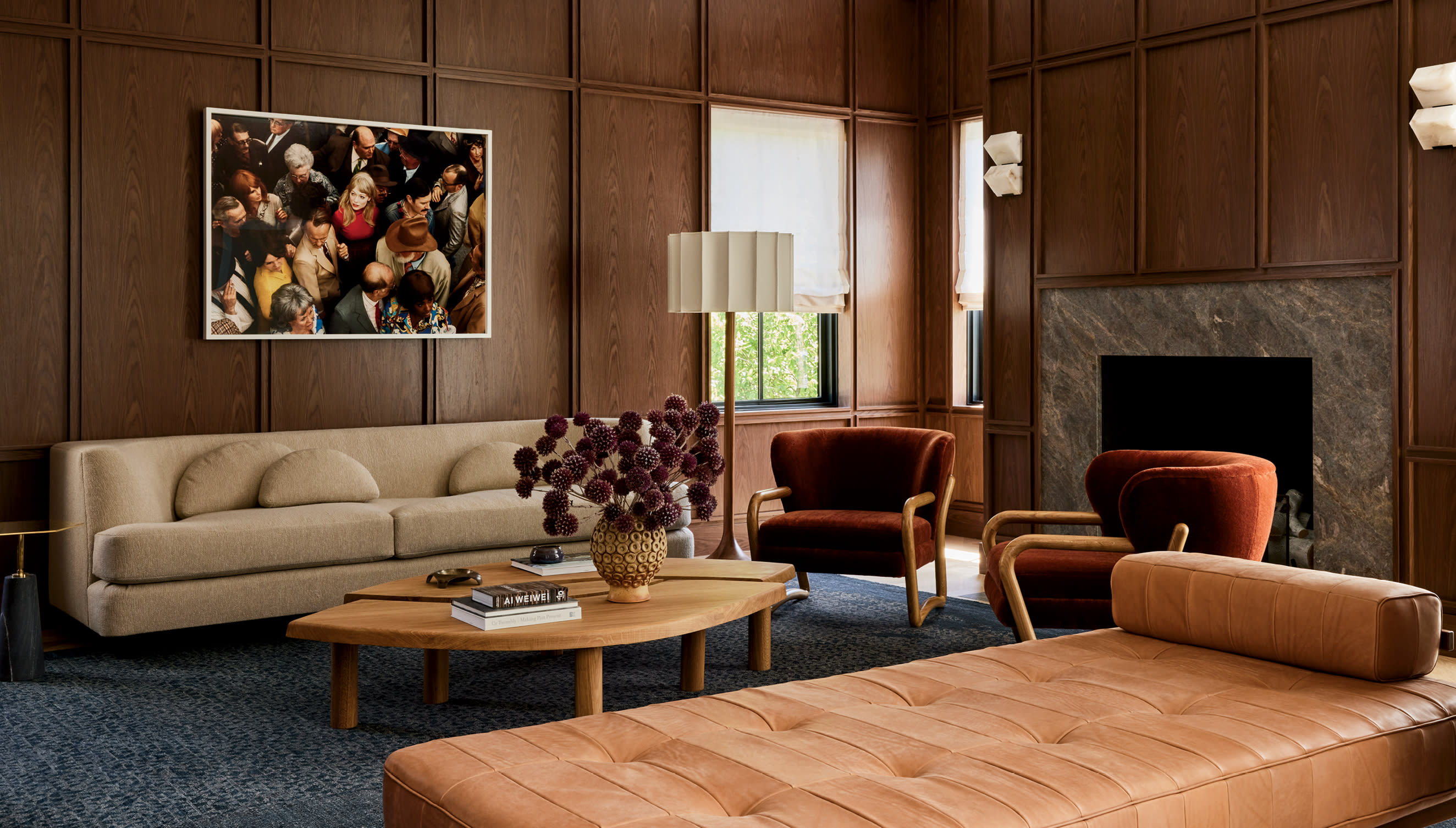 midcentury-style living room with a leather settee and red armchairs