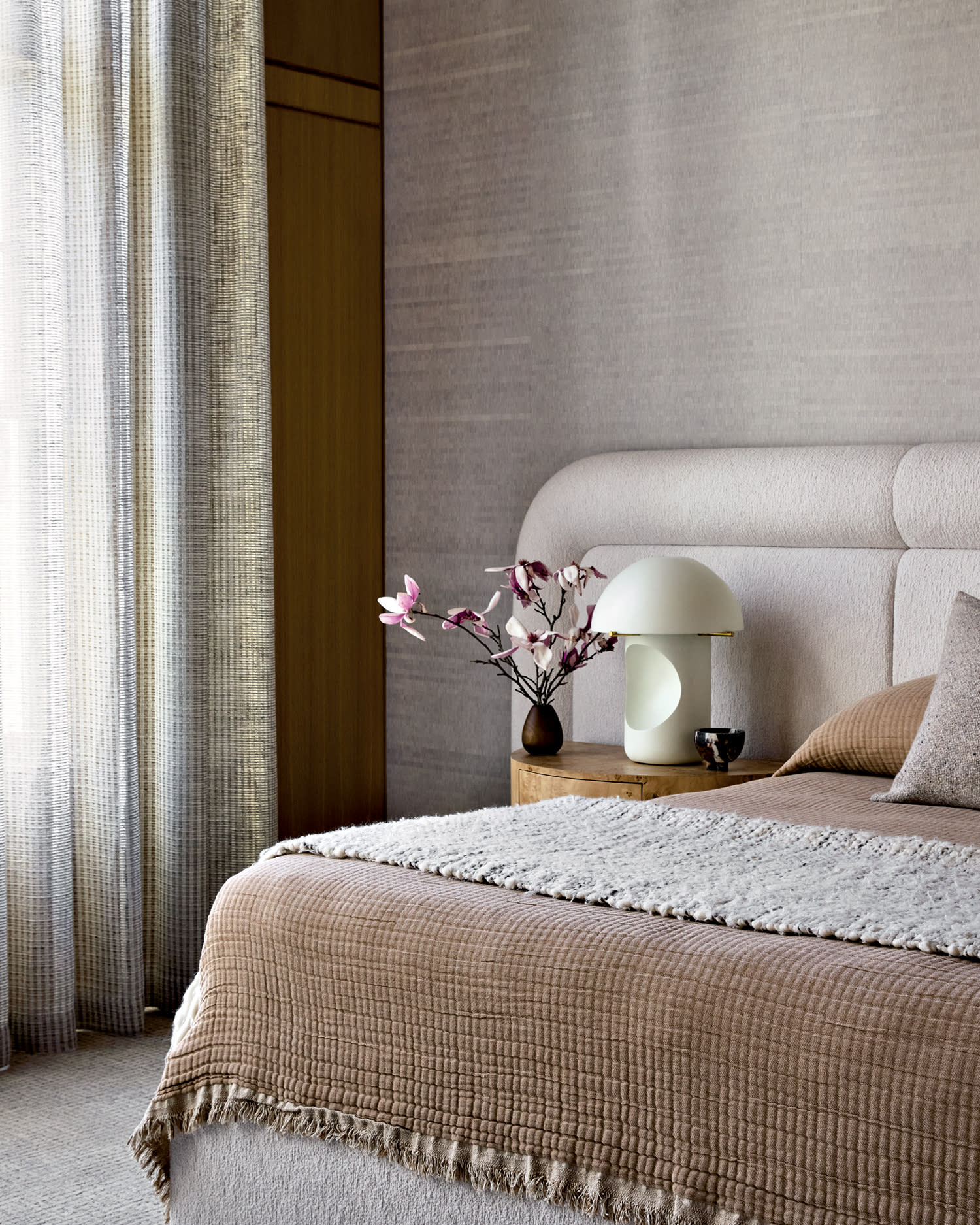 classic bedroom with a bed draped in natural-colored linens