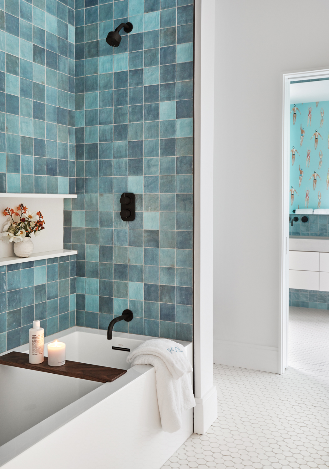 blue tiled shower and white tile flooring