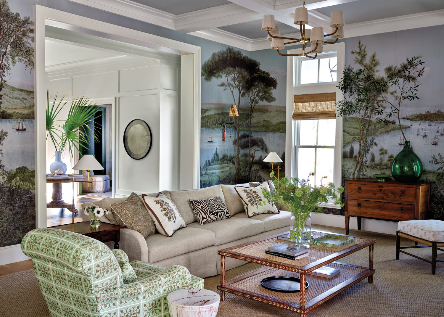 scenic landscape wallpaper wraps around a traditional living room