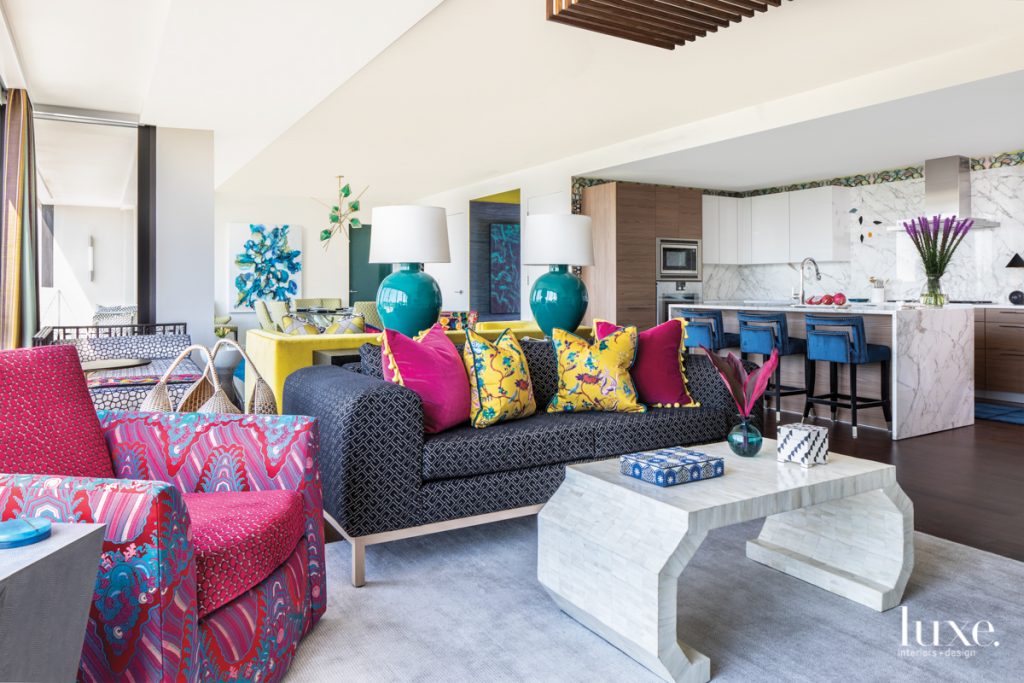 Patterns abound in the living room lounge, where a House + Town custom sofa wears a geometric Sahco fabric and holds throw pillows covered in pink Designers Guild fabric and a Clarence House print. Lamps are from Paul Schneider Ceramics; the Worlds Away coffee table is a grounding element.