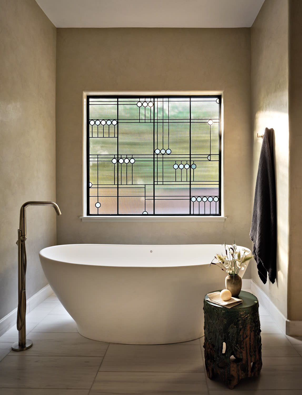 minimalist bathroom with a soaking tub and marble floor tiles