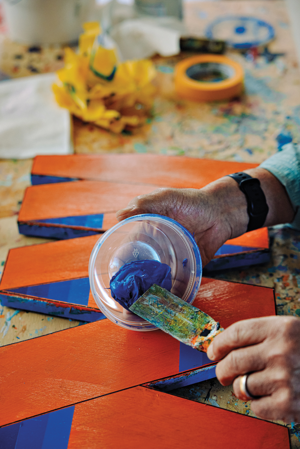 Howard Hersh troweling paint on a framework