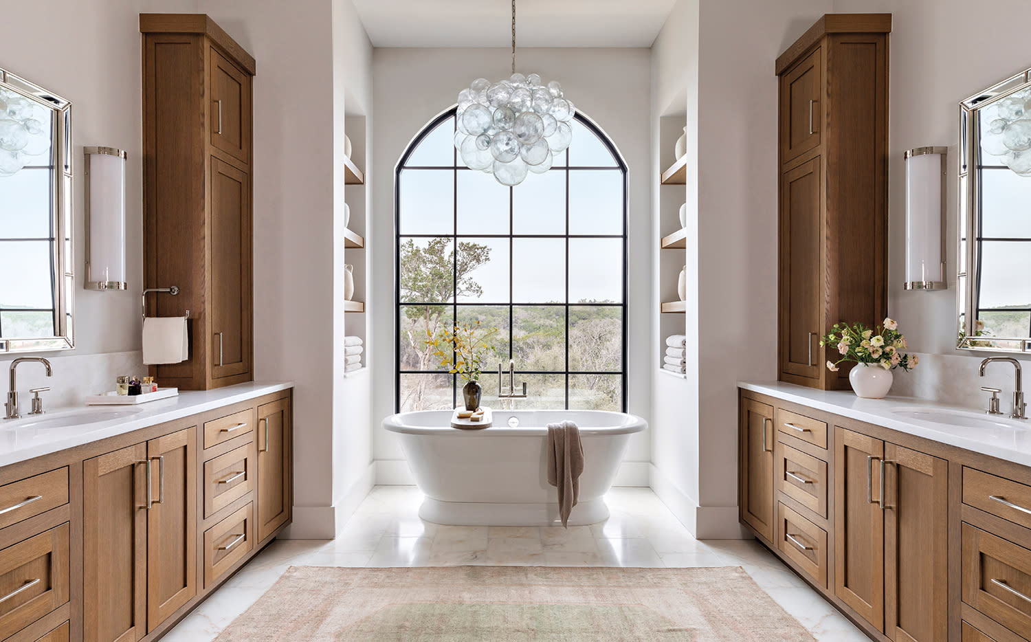 luxurious bathroom with a traditional tub in front of a window facing Texas Hill Country views