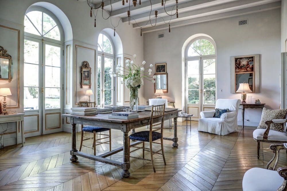 French inspired study with neutral walls and hardwood floors and