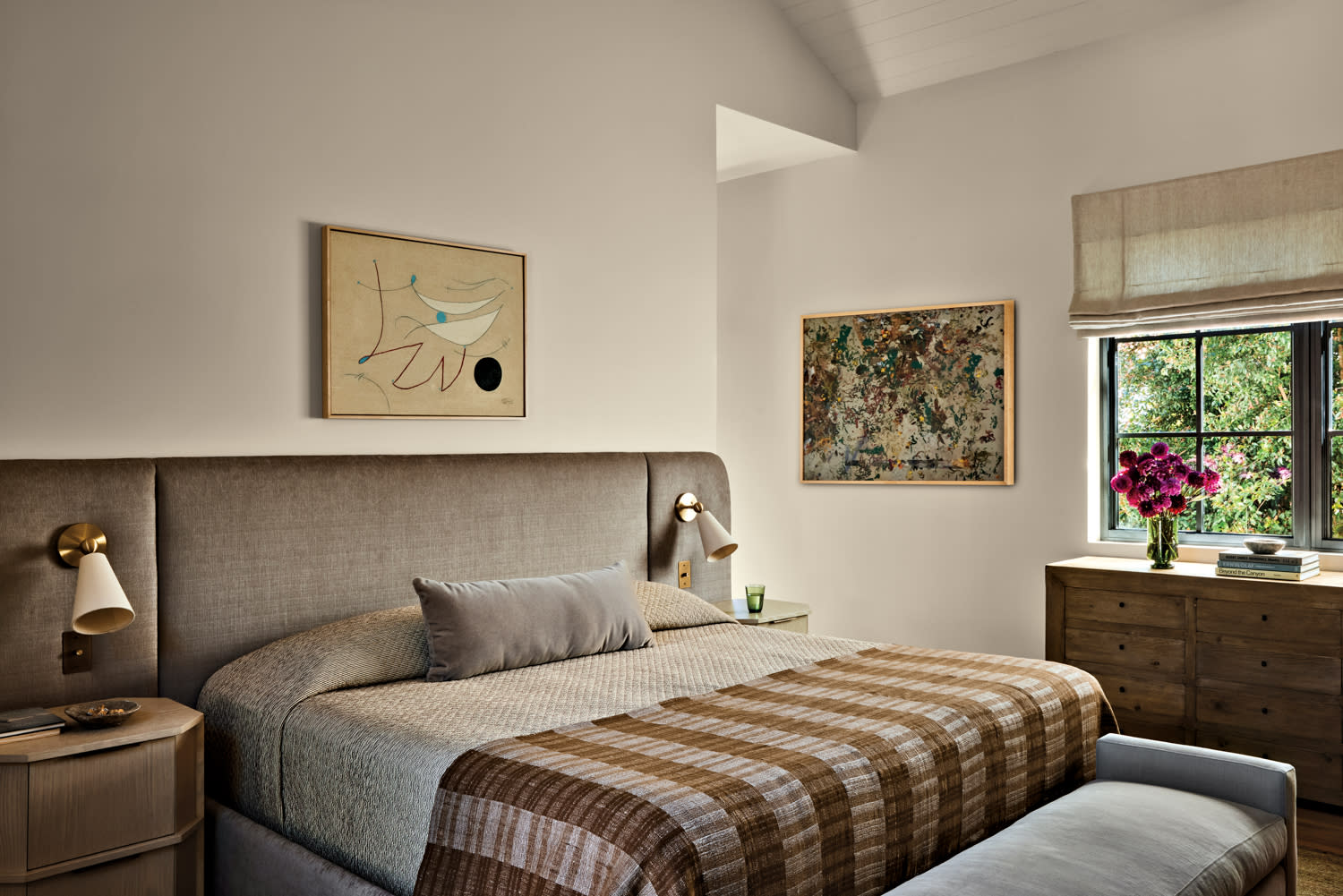 contemporary neutral bedroom with an upholstered headboard going the length of the wall
