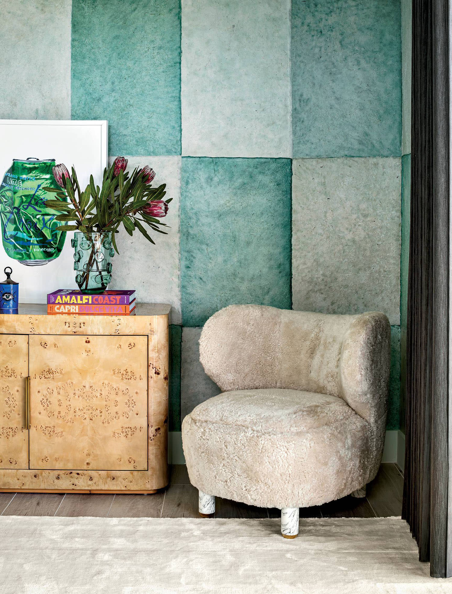 blue checker pattern wallcovering and an armchair in a guest bedroom