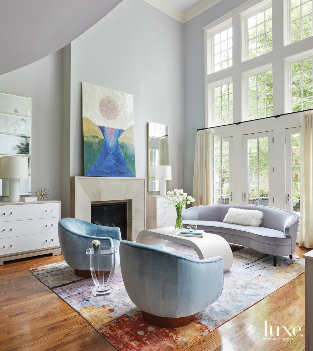 living room with tall ceilings and windows and a fireplace