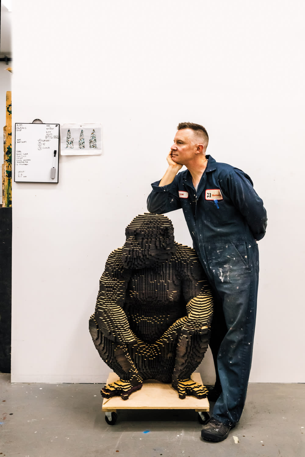 Shawn Smith with a sculpture of a chimpanzee