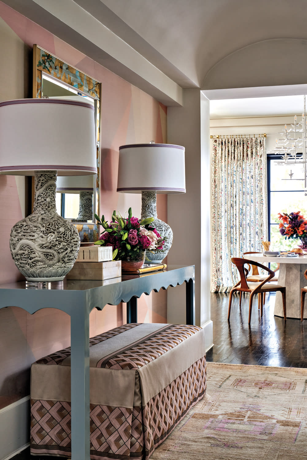 entry hall console area with bold wallpaper and furnishings