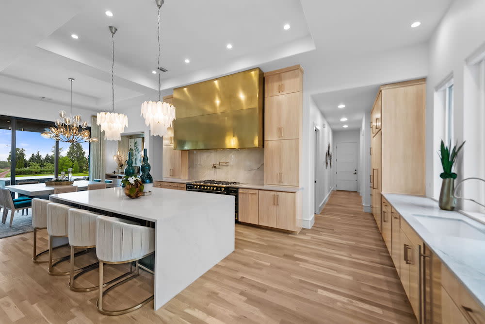 Contemporary modern kitchen with waterfall stone island.