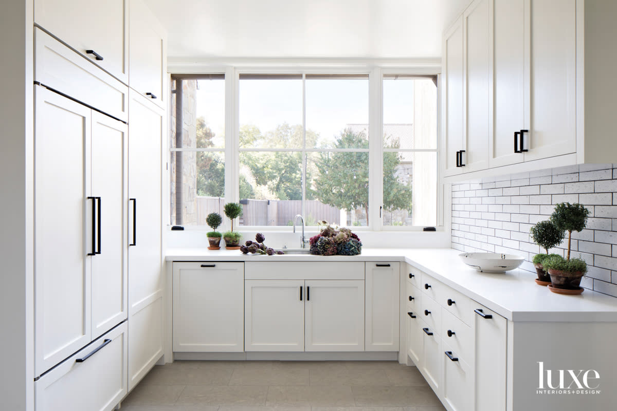 white pantry with laundry room and dark grout