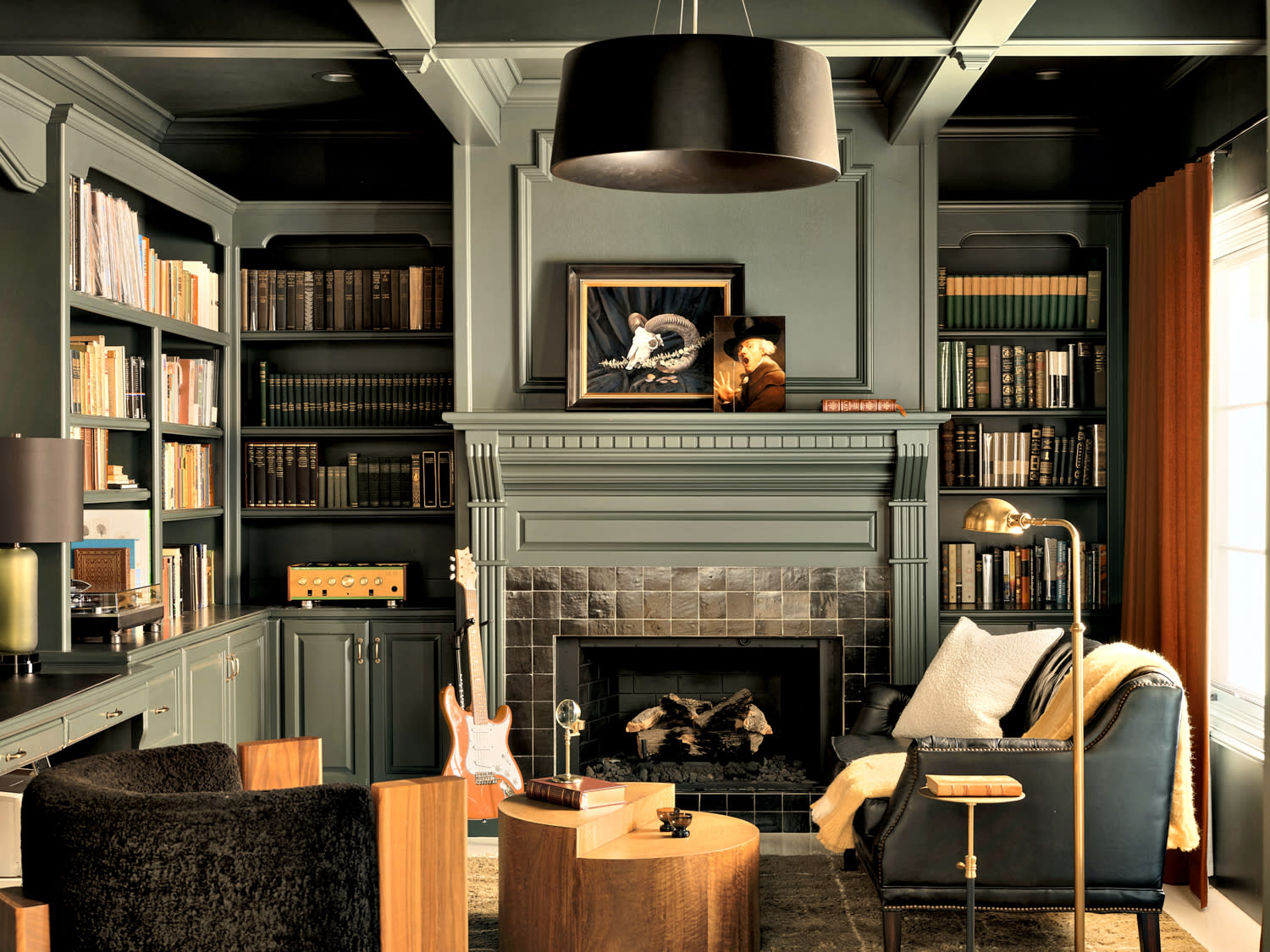 green and black home library with a leather settee