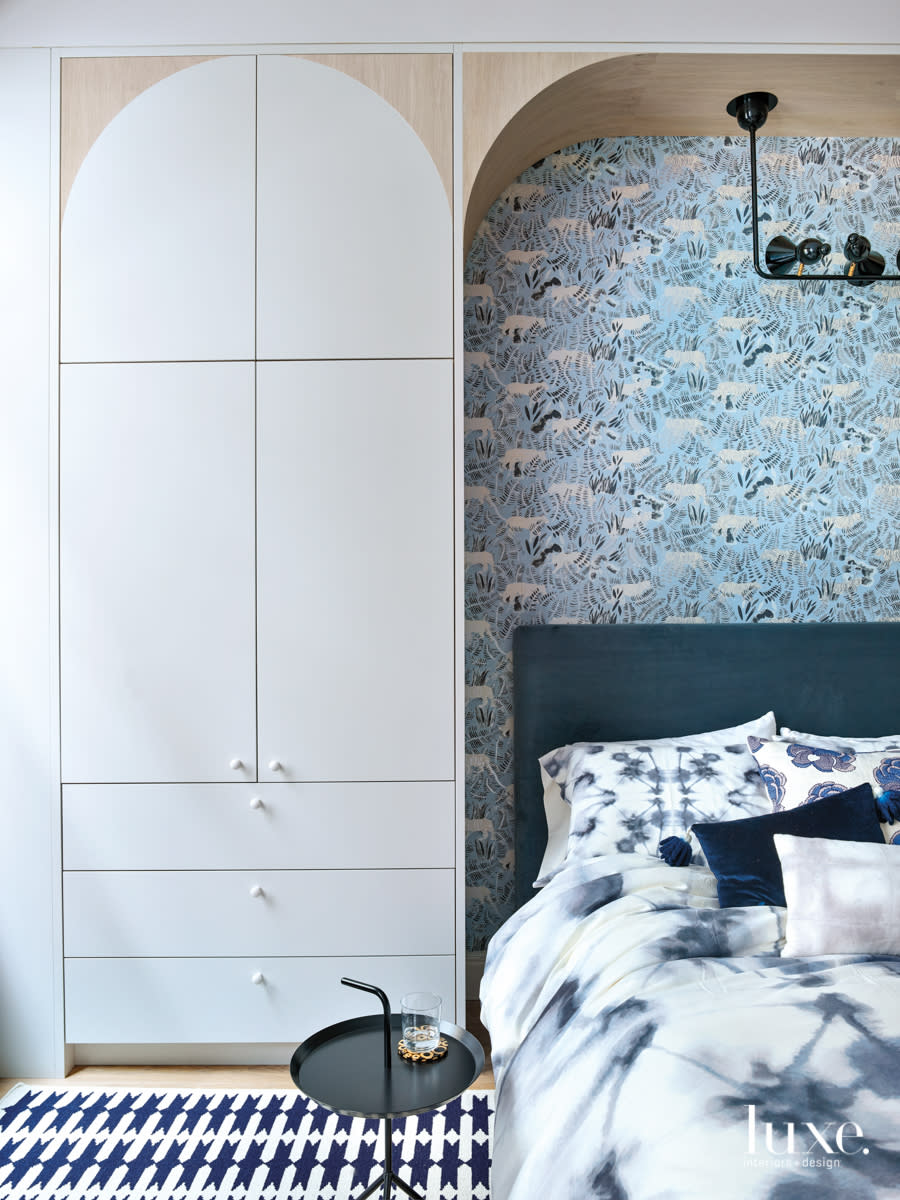 bedroom with blue walcovering, blue rug and blue bed