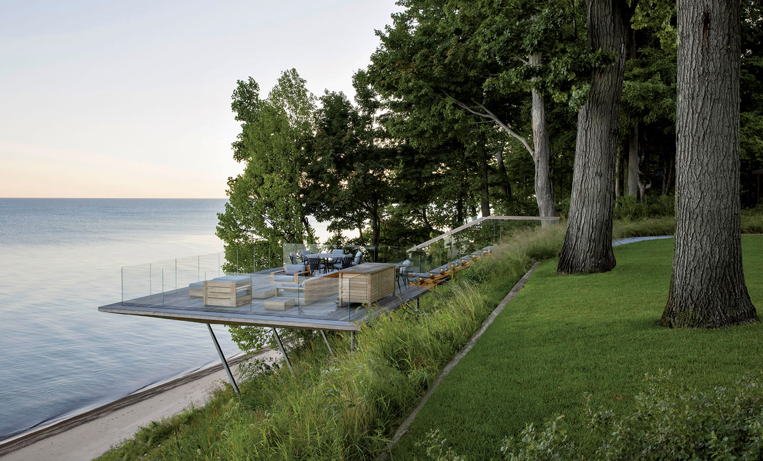 glass-enclosed cantilevered patio floating above a bluff looking over the lake