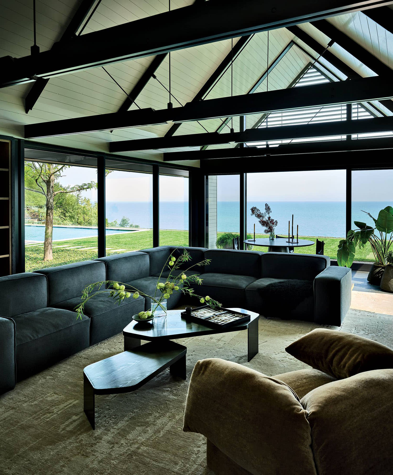 modern glass-walled living room with lake views outside