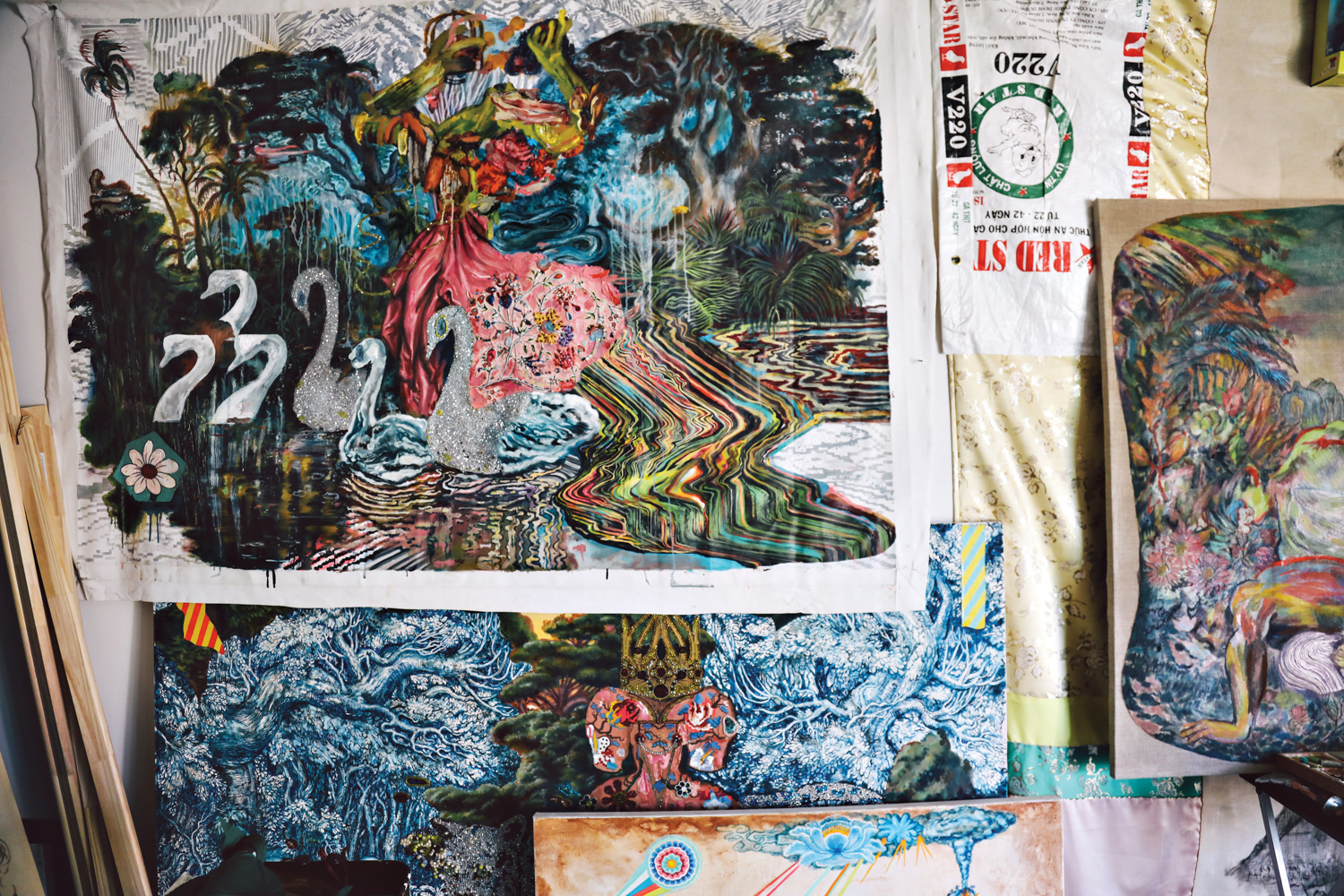 Detail show of a mixed-media artwork by Ken Gun Mix depicting swans covered in shining beads.