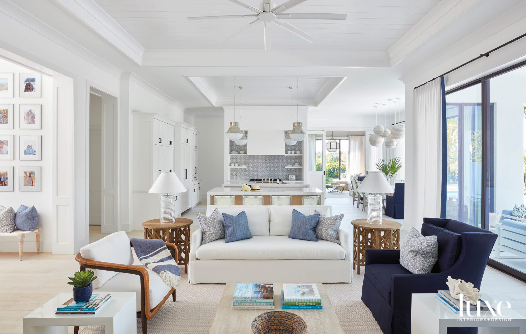 living area with white sofa, navy armchair and tan accents