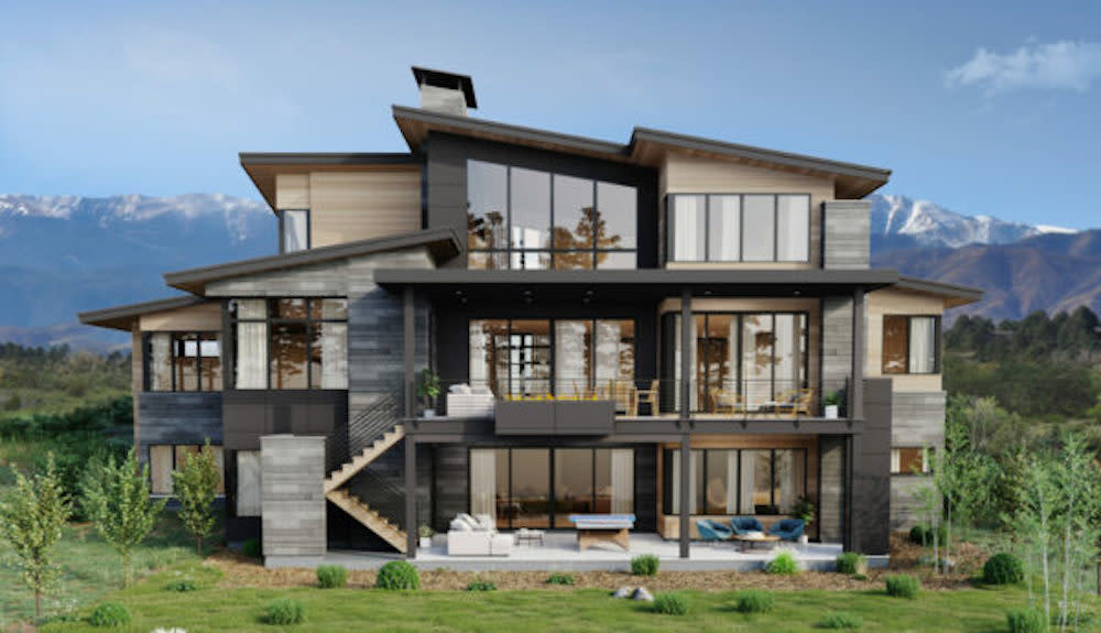 Exterior view of this three story mountain home. The back of the home is mainly windows to take in the views. There are balconies on the first and second stories to allow for indoor outdoor living.